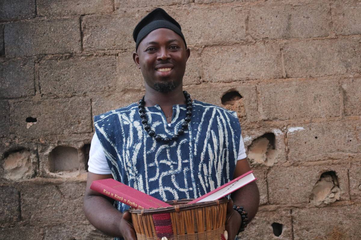 Man from the Weh community in Yaoundé, Cameroon holding a New Testament.